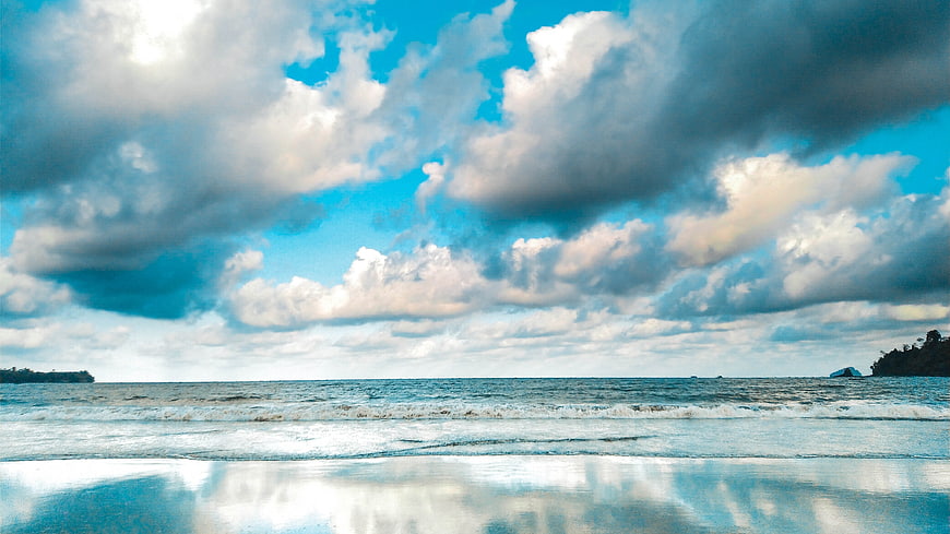 Dramatic Seascape with Cloud Reflections on Wet Beach