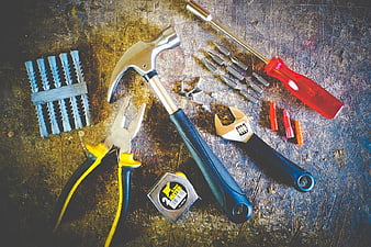 Assorted Hardware Tools on Rusty Metal Surface