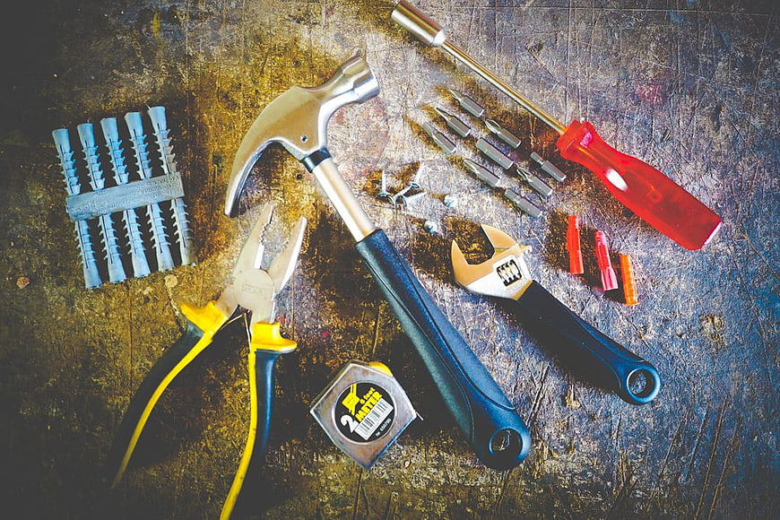 Assorted Hardware Tools on Rusty Metal Surface