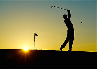 Silhouette of Golfer Swinging Club at Sunset