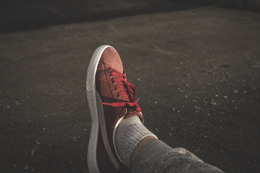 Red Suede Sneaker on Asphalt Ground
