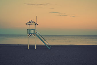 Lonely Lifeguard Tower on Empty Beach at Sunset