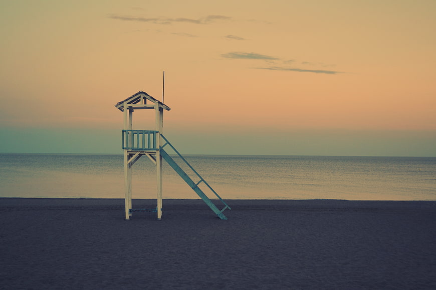 Lonely Lifeguard Tower on Empty Beach at Sunset