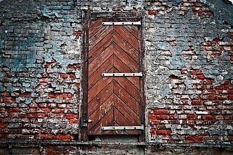 Weathered Brick Wall with Closed Wooden Shutters