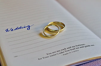 Gold wedding rings on open Bible with Psalm 31:3
