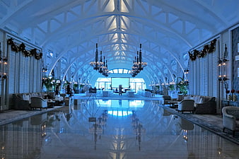 Luxurious Hotel Lobby Interior With Polished Floor Reflections And Chandeliers