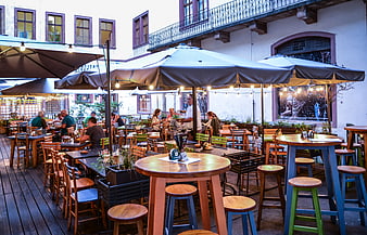 Outdoor restaurant terrace in Prague with wooden tables and umbrellas