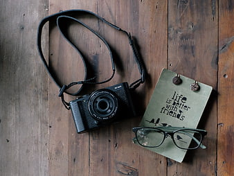 Vintage Camera, Glasses, and Notebook on Wooden Table