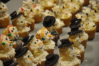 Festive Snowman Cupcakes with Oreo Hats and Coconut Frosting