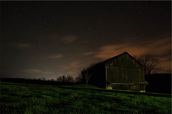 Rustic Barn Under Starry Night Sky in Rural Field