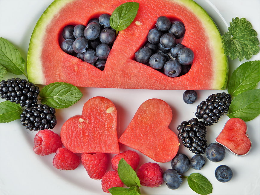 Heart-shaped watermelon and berries flat lay