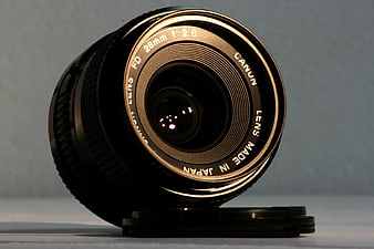 Vintage Canon FD 28mm Camera Lens on Gray Background