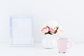 Minimalist white photo frame mockup with pink flowers and mug