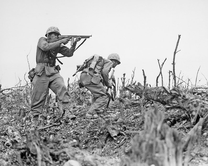 WWII soldiers advancing through devastated battlefield terrain