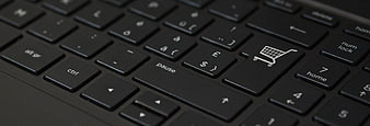 Close-up of a black keyboard with a shopping cart icon key