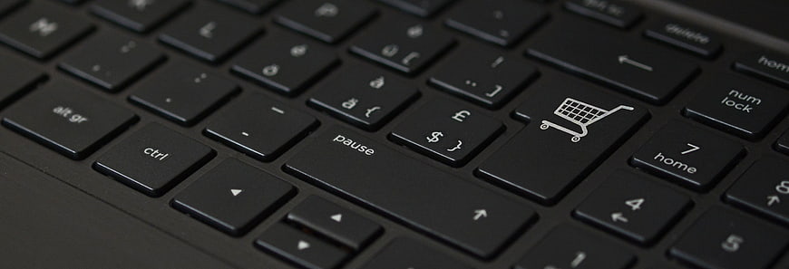 Close-up of a black keyboard with a shopping cart icon key