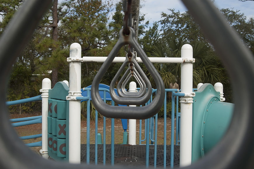 Symmetrical view of playground rings through climbing structure
