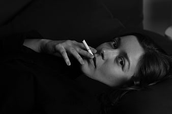 Black and white portrait of woman smoking cigarette