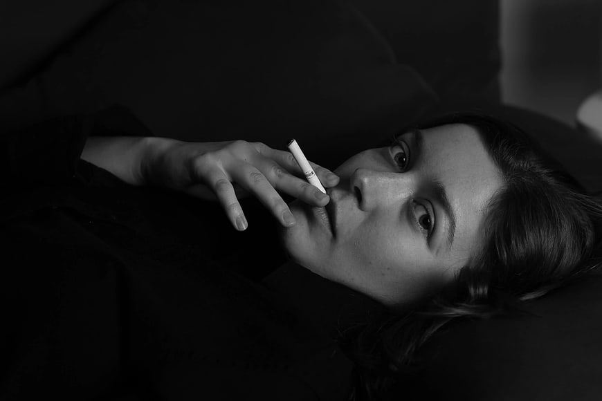 Black and white portrait of woman smoking cigarette