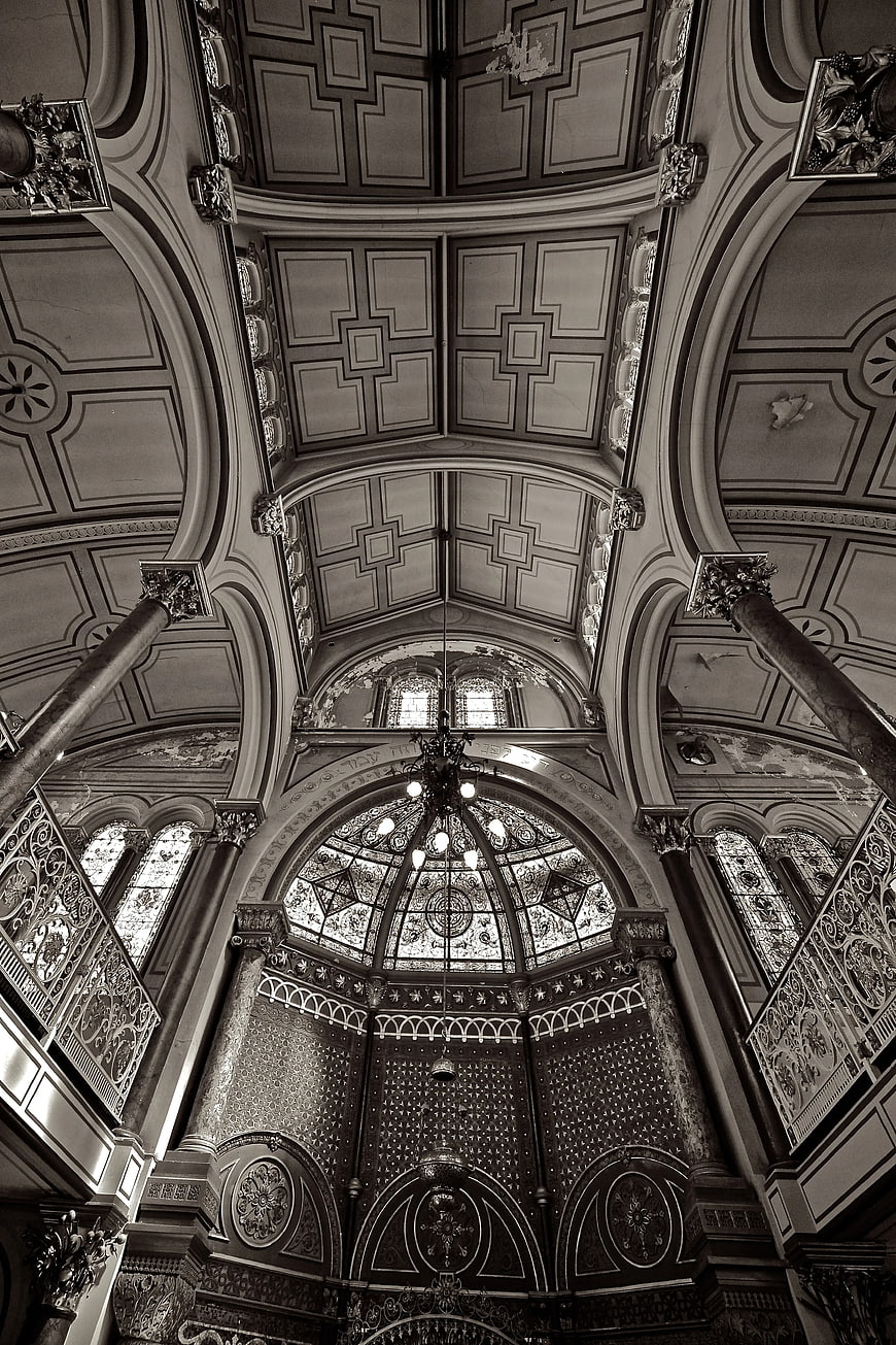 Black and white interior of ornate synagogue ceiling