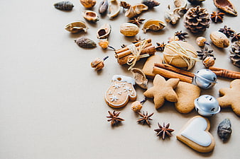 Christmas cookies, cinnamon, and spices on beige background