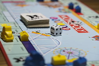 Close-up of Monopoly board game with dice and cards