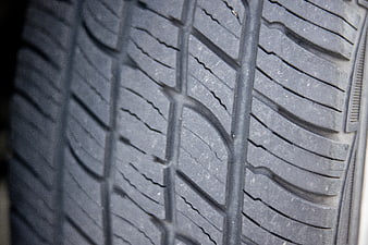Close-up of car tire tread pattern and rubber texture