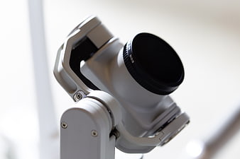 Close-up of white camera gimbal stabilizer with ND filter