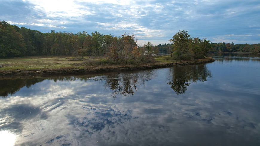 Serene Autumn River Landscape with Cloud Reflections