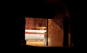 Long Exposure Night Photography of Moving Car Through Dark Archway