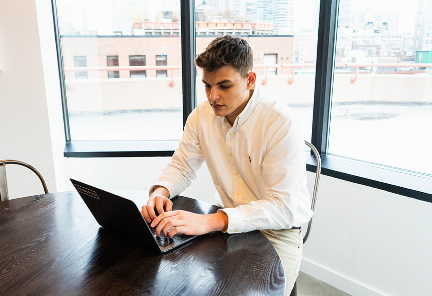 Young man working on laptop in modern office