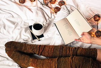 Cozy Reading in Bed with Coffee and Fairy Lights