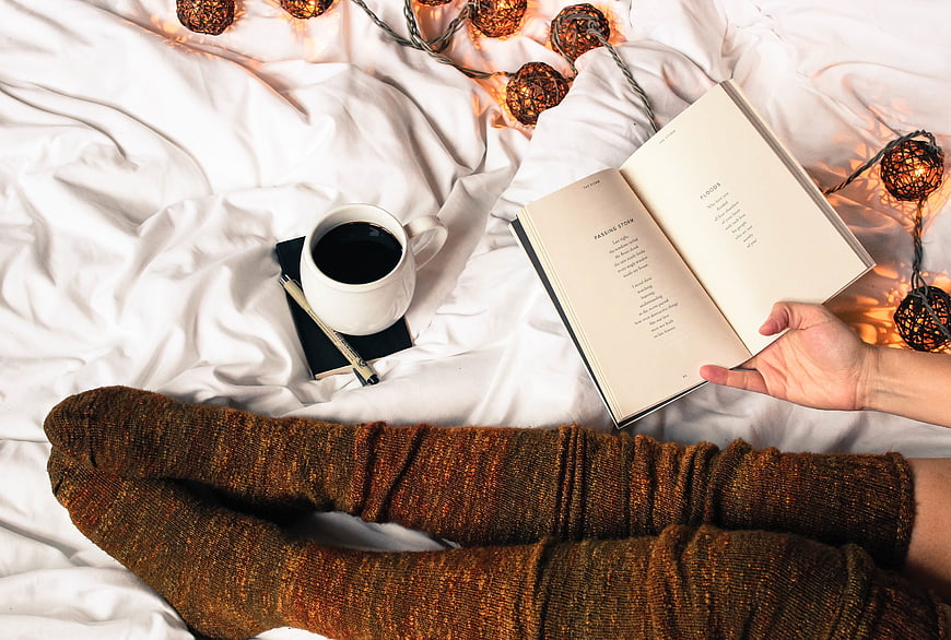 Cozy Reading in Bed with Coffee and Fairy Lights