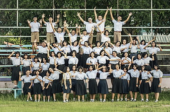 Group of Thai students in school uniforms posing outdoors
