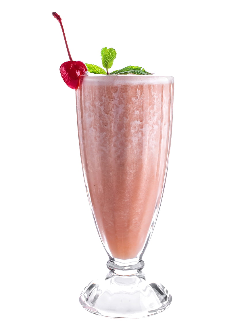 Refreshing Strawberry Milkshake with Cherry and Mint Garnish
