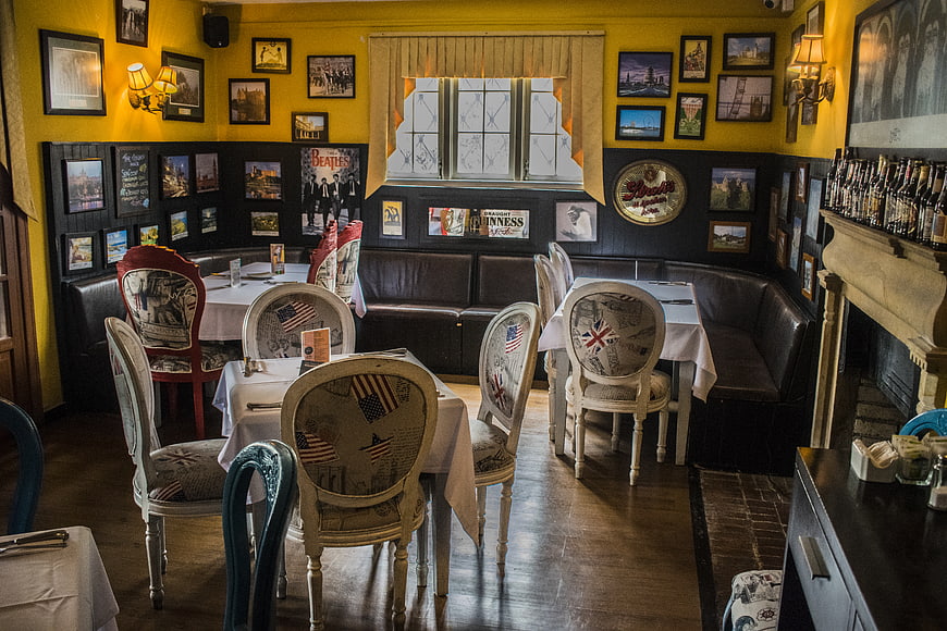 Interior of a British-themed restaurant with yellow walls and eclectic decor