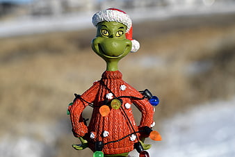Grinch Figurine Wearing Santa Hat And Christmas Lights