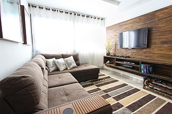 Modern Living Room with Brown Sectional Sofa and Wood Wall