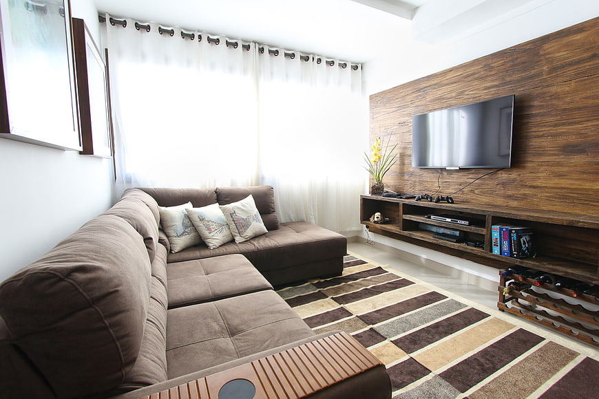 Modern Living Room with Brown Sectional Sofa and Wood Wall