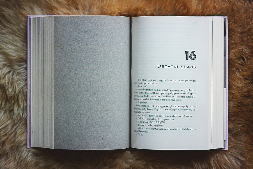 Open book on brown fur background with chapter text