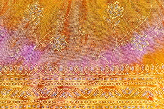 Textured fabric with intricate floral embroidery and golden patterns