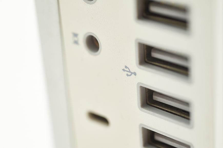 Close-up of white USB ports and audio jack on computer