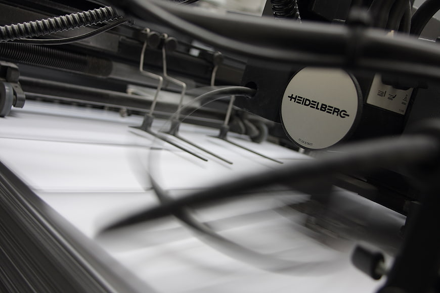 Close-up of Heidelberg printing press in motion