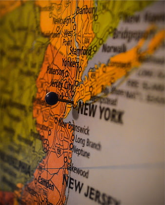 Close-up of a pushpin on a map of New York and New Jersey