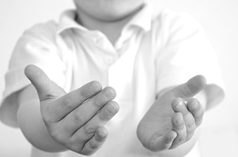 Child with open hands reaching out for help