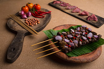 Grilled Beef Satay Skewers with Raw Ingredients on Wooden Boards