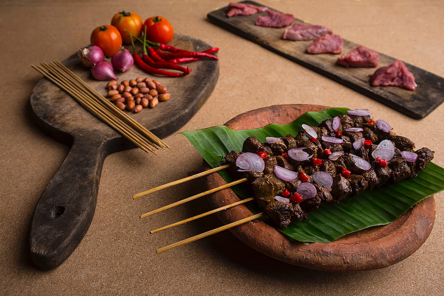 Grilled Beef Satay Skewers with Raw Ingredients on Wooden Boards