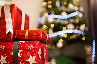 Red Christmas Gifts Under Blurred Tree