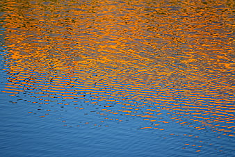 Golden Sunset Reflections On Rippling Water Surface