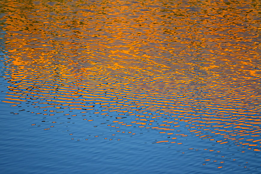 Golden Sunset Reflections On Rippling Water Surface